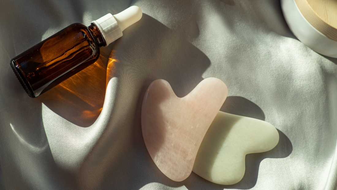Gua sha facial tools and oil