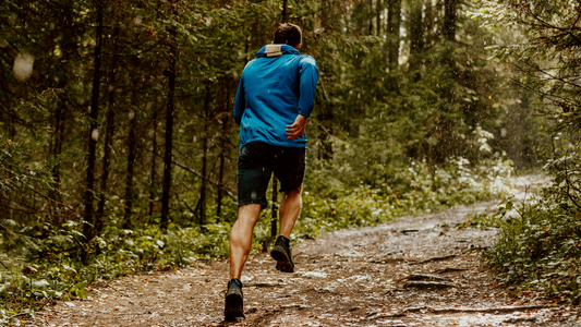 Man running through forest 