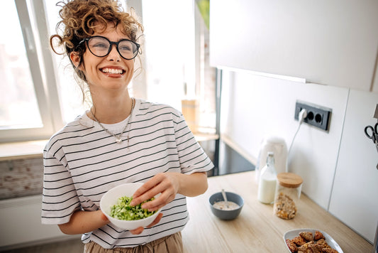 Young women preparing and eating morning meal